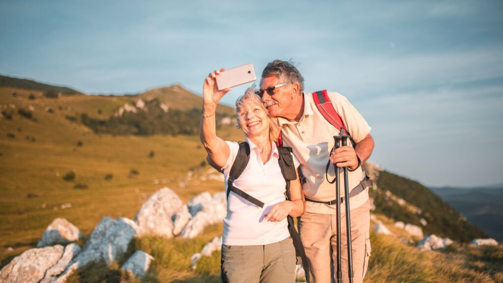 older couple taking a selfie up a hill